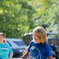 Alumna carrying a box into a dorm.